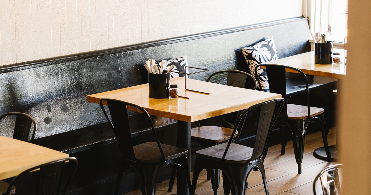 Lined up wooden tables and metal chairs