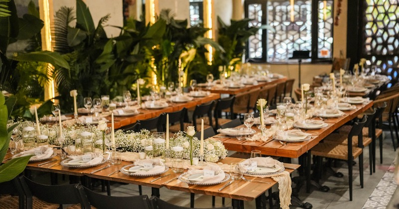 Nicely designed upscale restaurant interior with elegantly set dining tables prepared for a wedding