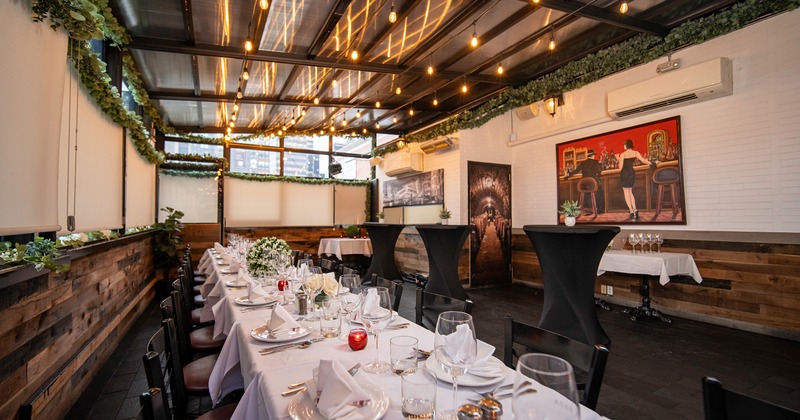 An elegant dining setup in an enclosed patio space set up for a formal occasion