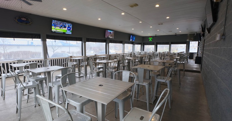 Covered patio area, tall tables and bar stools