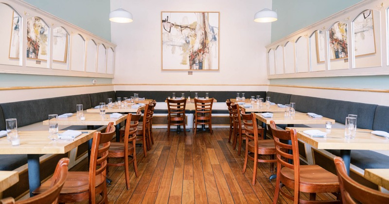 Interior, tables, chairs and long seating bench in dining area