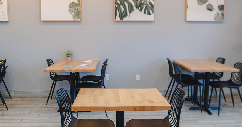 Interior - three tables, chairs, pictures on the wall