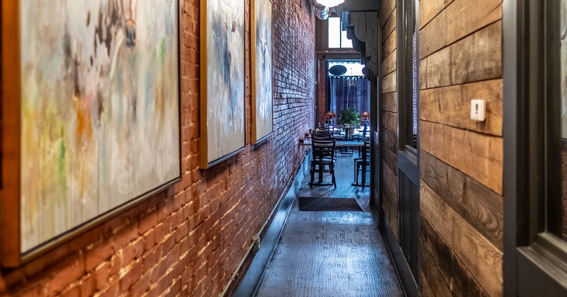 Diner area  in the background, view through a narrow corridor