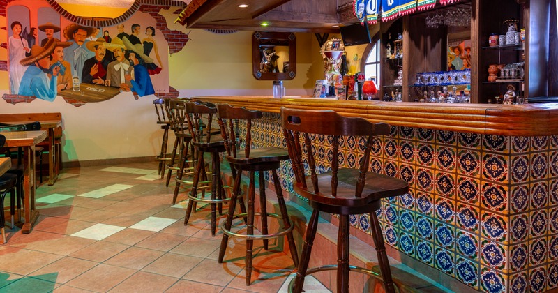 Interior, bar with colorful tiles and art on the wall