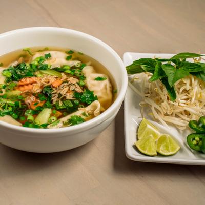 Egg noodle soup with dumplings.