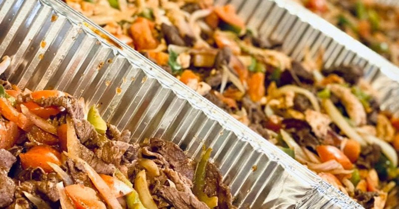 Catering dishes filled with stir-fried meat and vegetables