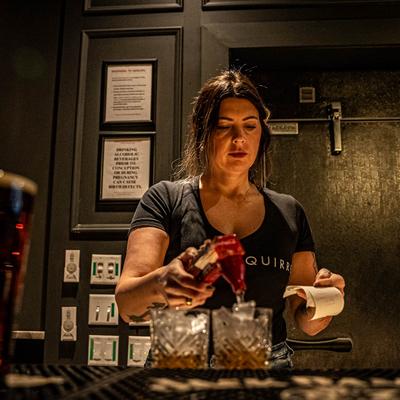 A bartender fixing a drink.