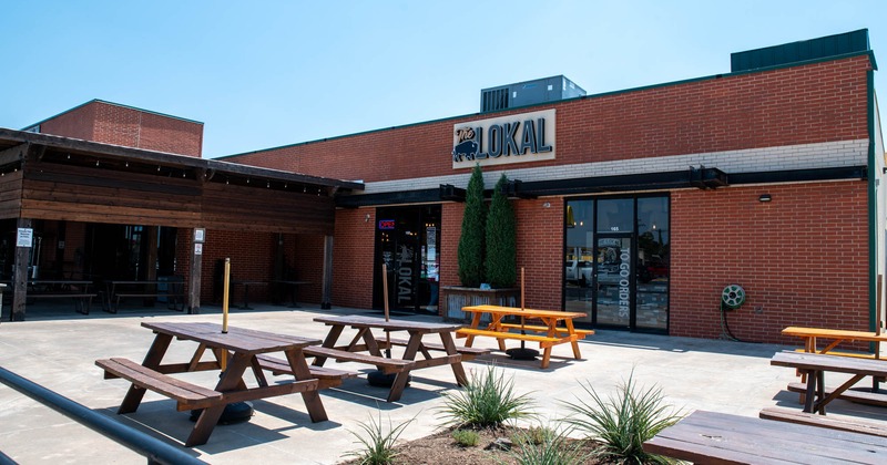 Restaurant exterior with picnic tables on a sunny day