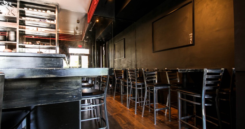 Interior, bar area with employees standing behind the bar