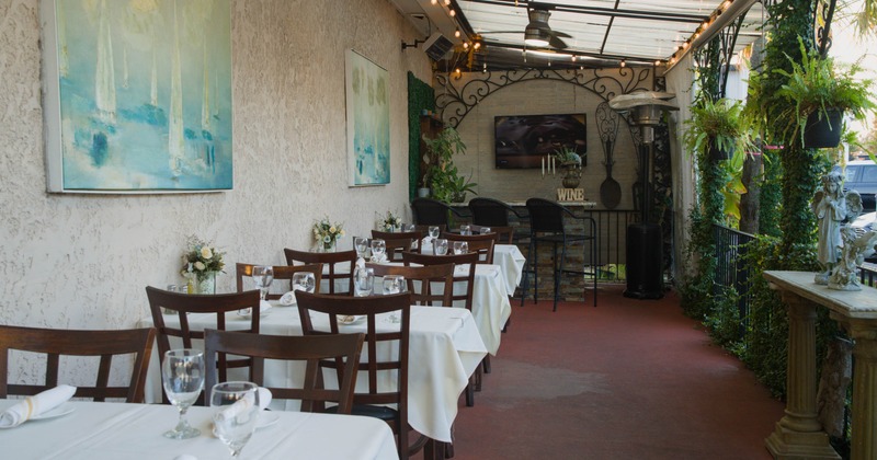 Covered seating area with wooden chairs and tables
