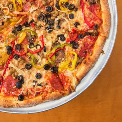 Pizza with pepperoni, sausage, peppers, onions, black olives, and cheese.