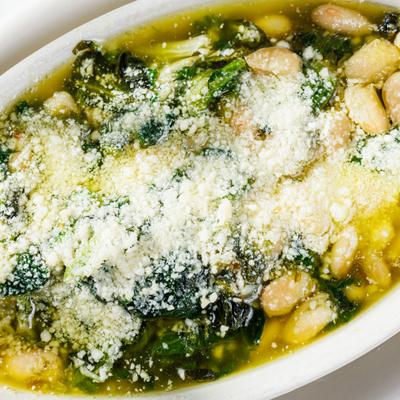 Appetizer dish greens and beans, closeup.