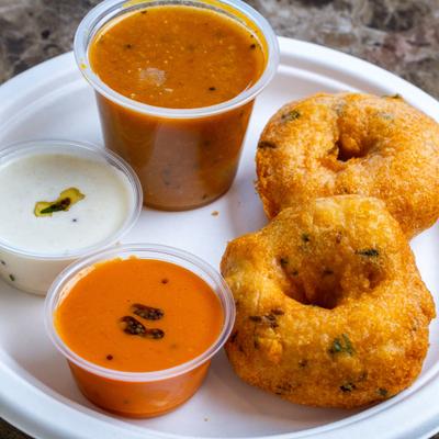 Deep fried doughnut shaped lentil fritter served with lentil stew and chutneys.