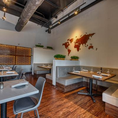 Interior with booths, tabless, chairs and world map decoration on the wall.