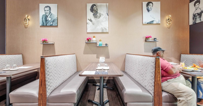 Interior, inline booths by a wall decorated with black and white pictures