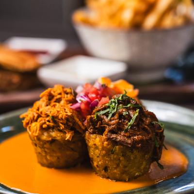Three smashed fried plantains stuffed with shrimps, chicken, and beef.