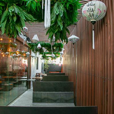 Interior with wood paneling, lanterns, and hanging greenery.