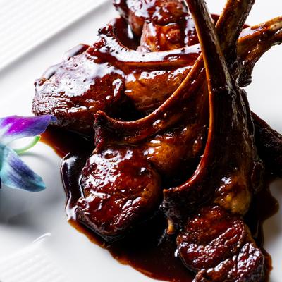 Lamb chops with asparagus on the side, close up.