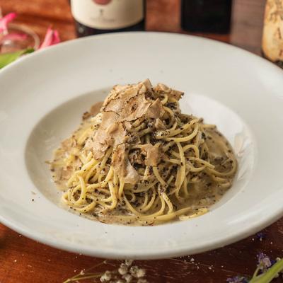 Creamy mushroom pasta on a white plate.