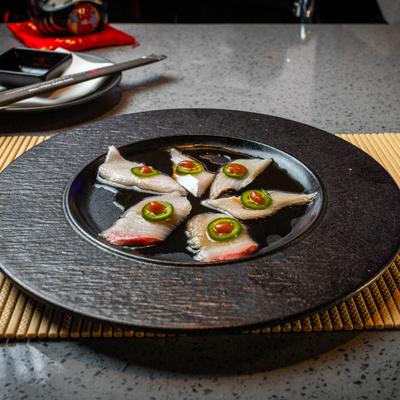 Yellowtail Jalapeno served in yuzu ponzu sauce.