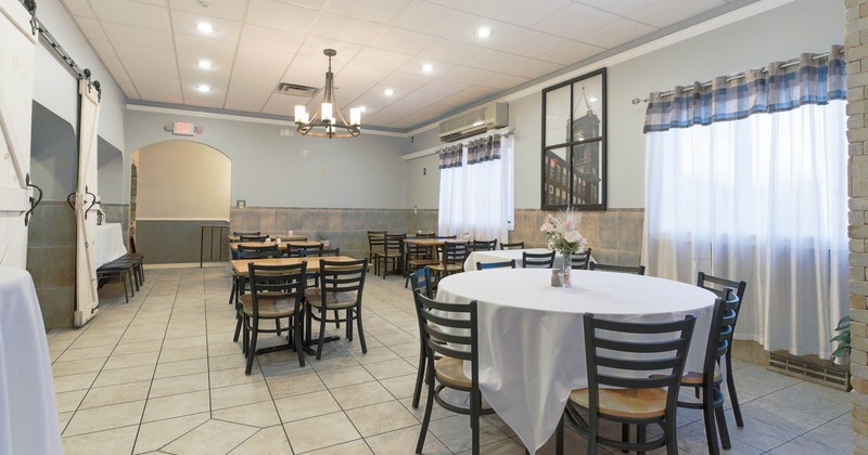 Dining room with tiled floors and light gray walls