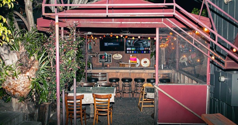 Exterior, garden, tables and chairs, bar behind