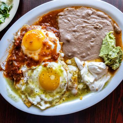 Huevos Divorciados with fried eggs, beans, sour creme and guacamole.