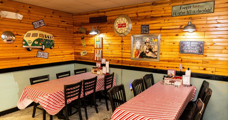 Dining space with wooden panels and retro decorations on the wall