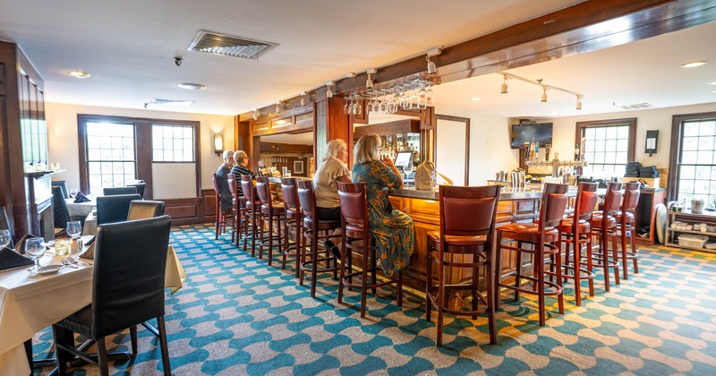 Restaurant bar area with counter seating and dining tables
