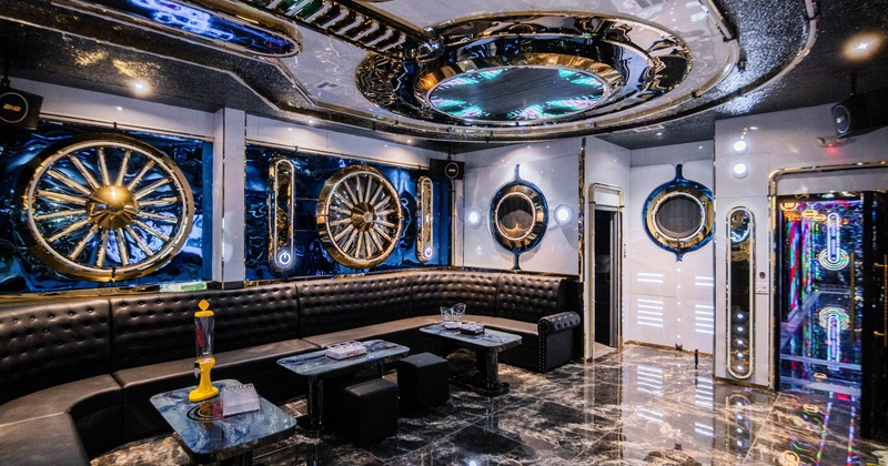 Interior, karaoke room, nautical theme, marble tile flooring, large leather sofa
