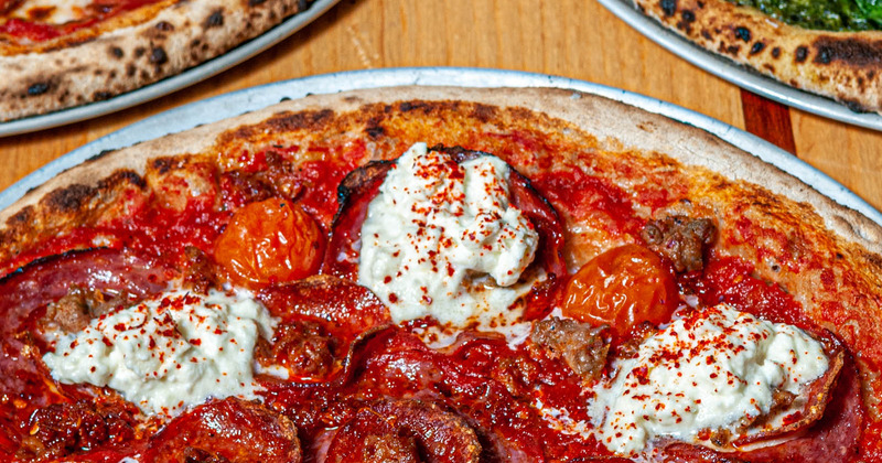 Pizza with tomato sauce, closeup