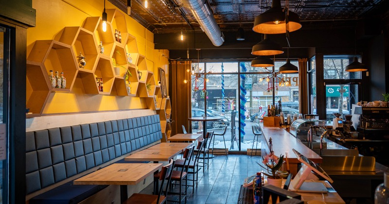 A cozy interior with hexagonal shelves and a bar counter.