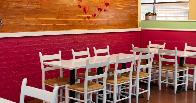 Interior space, lined up white tables and chairs