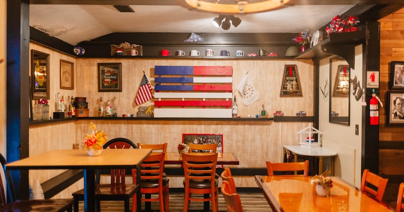 Interior, seating area with decorated wall and tables