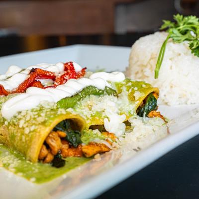 Spinach and Chicken Enchiladas,  with green salsa, cheese, and rice.