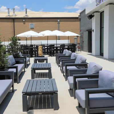 Tables and chairs outside on the patio.