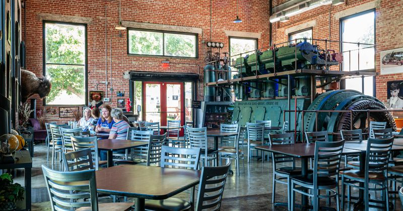 Interior, dining area with tables and big, outdated machine