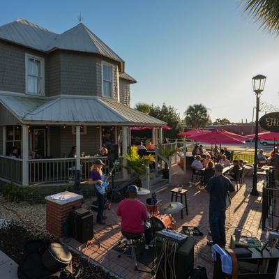 The outdoor patio in the sunset, with people.