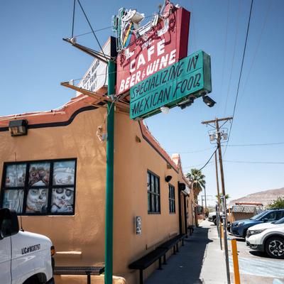 Exterior with signage, Day of the Dead window designs.