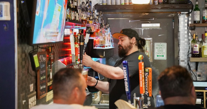 Bar, barmen pouring the beer