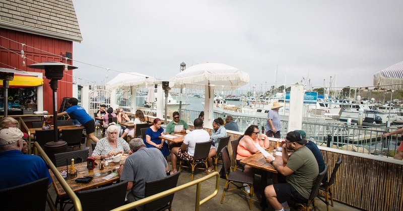 Outside, guests dining, view of the harbor