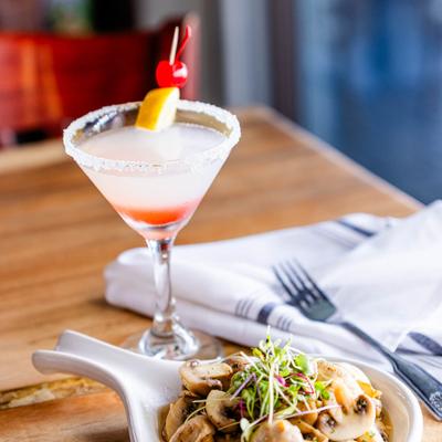 A served meal and a cocktail.