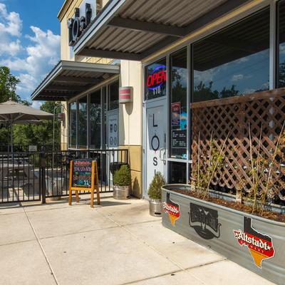 Storefront with signage and an 'Open' sign.