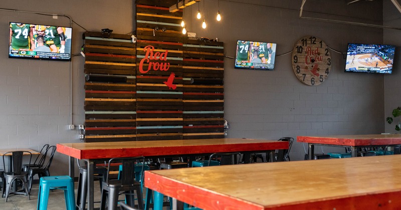 Tall tables and bar stools, TVs on the wall