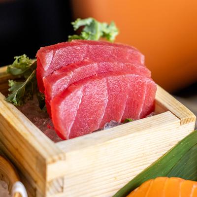 Sashimi Platter featuring fresh tuna served in a traditional wooden box.