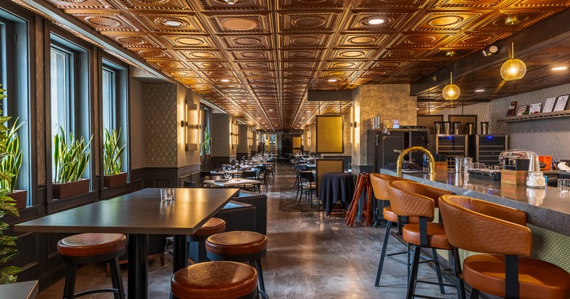 Interior, tables and chair ready for guests with bar on the right side