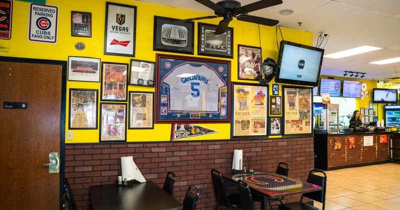 Tables and chairs by decorated wall