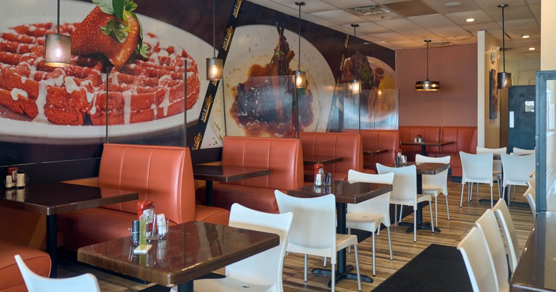 Interior, dining area, tables for two, seating booths with tables in the back,