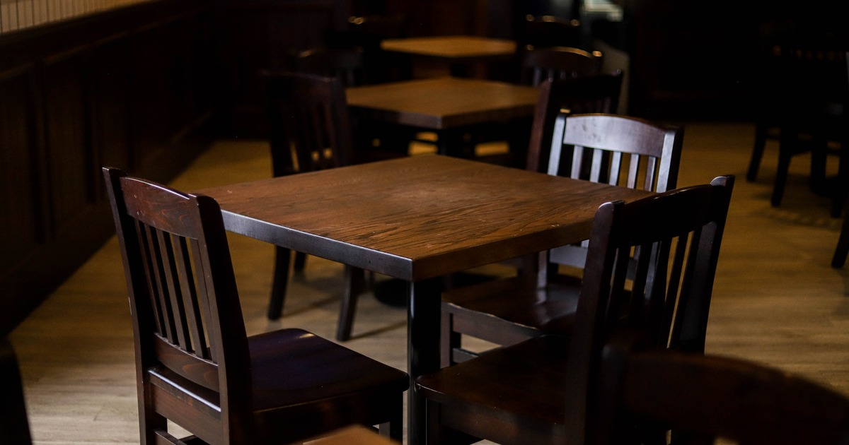 Pub's interior, elegant and spacious bar with a large, U-shaped wooden bar counter in the center