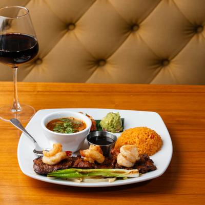 Carne Asada with shrimps, served on the table.